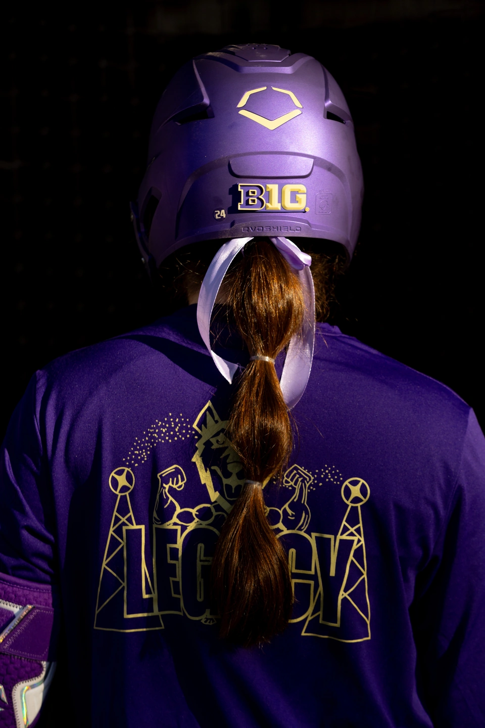 Back of a Washington softball helmet and jersey