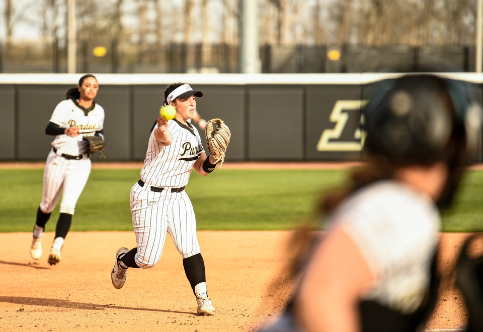 Purdue infielder throwing across the diamond