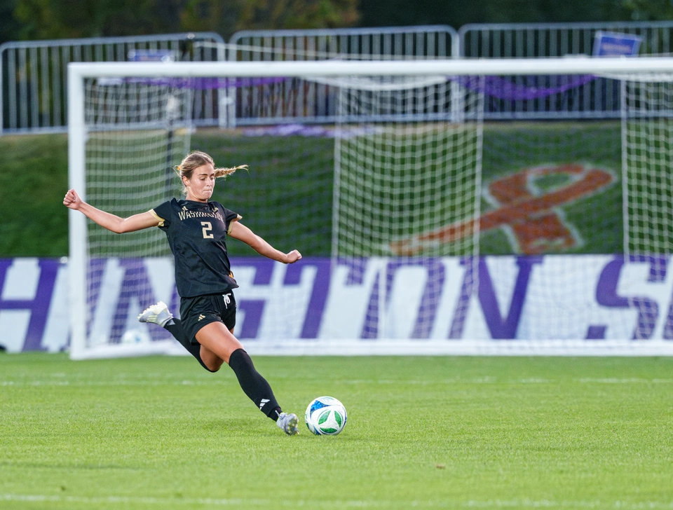 Washington defender Anna Menti strikes the ball on a free kick