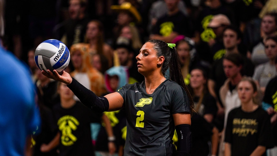 Purdue outside hitter Chloe Chicoine holds the ball up prior to serving