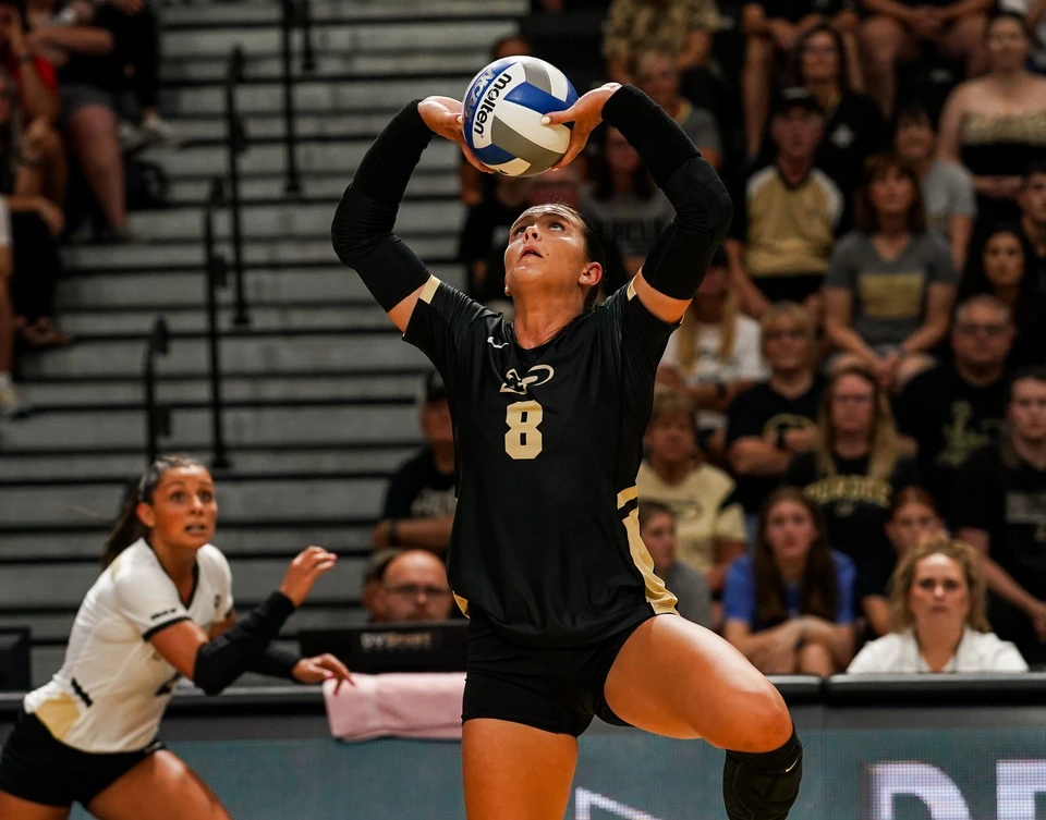 Purdue defensive specialist Maddie Schermerhorn jump-setting the ball
