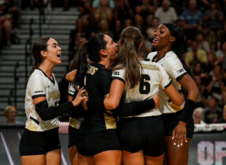 Teammates celebrate after winning a point